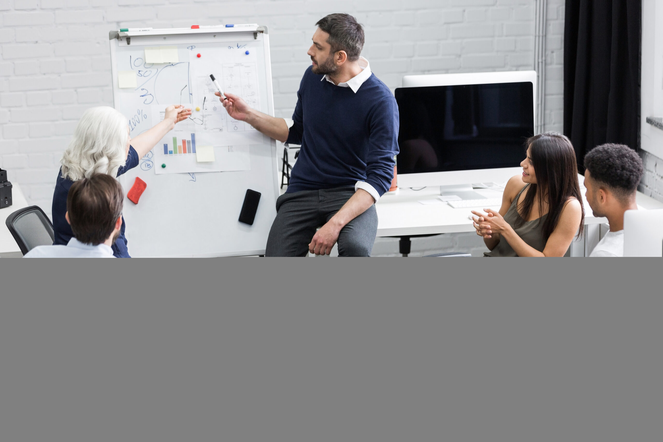 Creative people sitting at table in boardroom